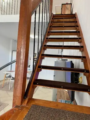 a staircase with wood and glass treads at Polikseni Apartment Orfanidou in Rhodes Town