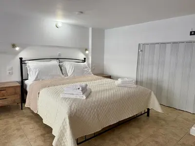 a bedroom with a bed with towels on it at Polikseni Apartment Orfanidou in Rhodes Town