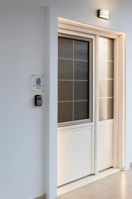 a door with a window in a room at Κatholikis Room in Kremasti