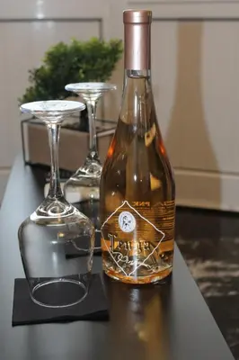 a bottle of wine on a table with two glasses at Κatholikis Room in Kremasti