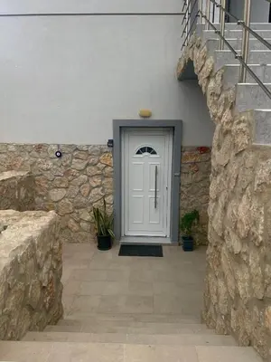 a white door on a building with a stone wall at Casa Guina Solis in Rhodes Town