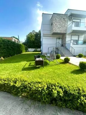 a yard with a house and a bench in the grass at Casa Guina Solis in Rhodes Town