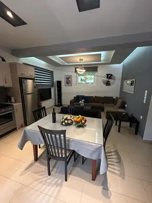 a living room with a table and a couch at Casa Guina Solis in Rhodes Town