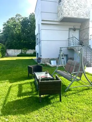 a yard with two chairs and a swing at Casa Guina Solis in Rhodes Town