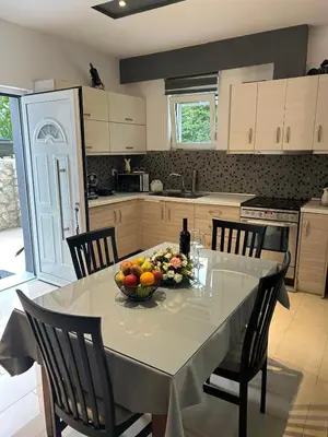 a kitchen with a table with a bowl of fruit on it at Casa Guina Solis in Rhodes Town