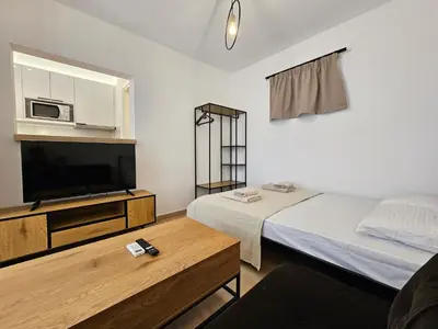 a small room with a bed and a tv at Elegant Aesthetic Suites in Rhodes Town