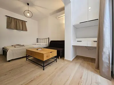 a living room with a couch and a table at Elegant Aesthetic Suites in Rhodes Town