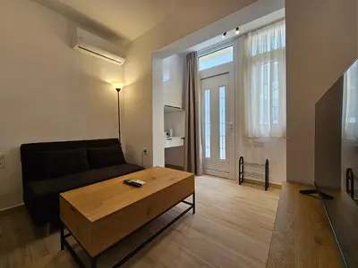 a living room with a couch and a coffee table at Elegant Aesthetic Suites in Rhodes Town