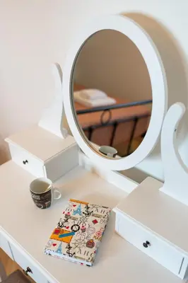 a white dressing table with a mirror and a box at Onour Apartment 1 in Ialyssos