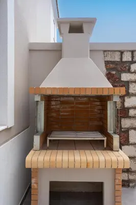 a stove top oven sitting on top of a balcony at Onour Apartment 1 in Ialyssos