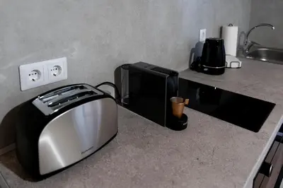 a kitchen counter with a toaster and a toaster oven at Eviona Iris in Rhodes Town