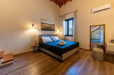 a bedroom with a blue bed in a room at Eviona Iris in Rhodes Town