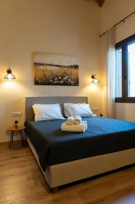 a bedroom with a bed with two towels on it at Eviona Iris in Rhodes Town