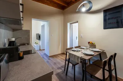 a kitchen and dining room with a table and chairs at Eviona Iris in Rhodes Town