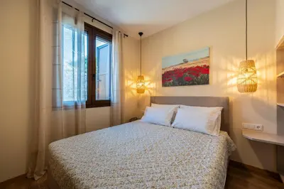 a bedroom with a bed and a window at Eviona Iris in Rhodes Town