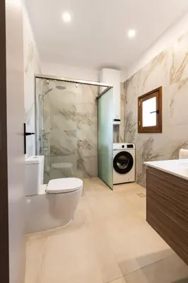 a bathroom with a toilet and a sink and a shower at Eviona Iris in Rhodes Town