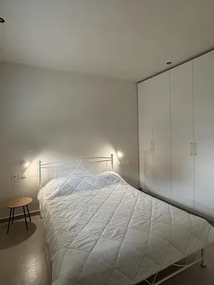 a bedroom with a white bed and a table at Sofi's place in Ixia