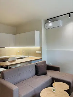 a living room with a couch and a kitchen at Sofi's place in Ixia