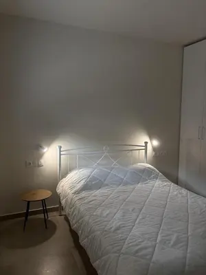 a bedroom with a white bed and a table at Sofi's place in Ixia