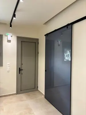 a large glass door in a room with a hallway at Sofi's place in Ixia