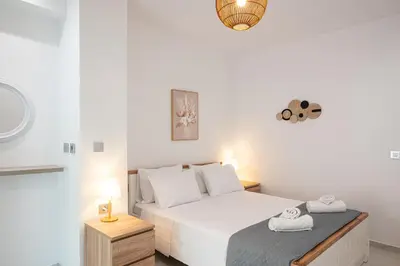 a bedroom with a white bed with two towels on it at Asterashouse 2 in Rhodes Town