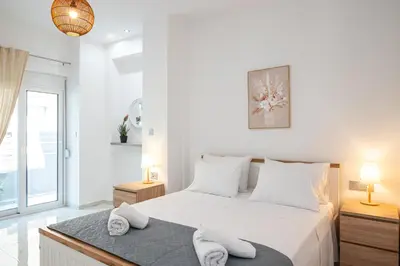 a white bedroom with a large bed with white pillows at Asterashouse 2 in Rhodes Town