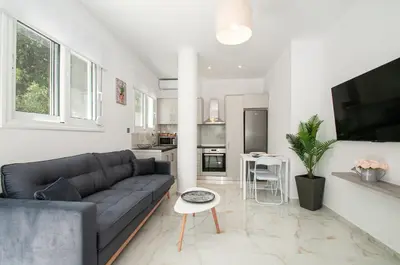 a living room with a couch and a tv at Asterashouse 2 in Rhodes Town