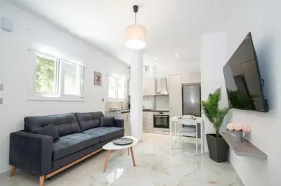 a living room with a couch and a tv at Asterashouse 2 in Rhodes Town