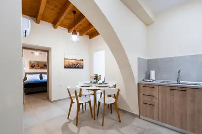 a kitchen and dining room with a table and chairs at Eviona Althea in Rhodes Town