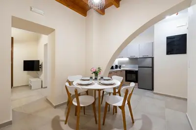 a kitchen and dining room with a table and chairs at Eviona Althea in Rhodes Town
