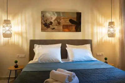 a bedroom with a bed with two towels on it at Eviona Althea in Rhodes Town