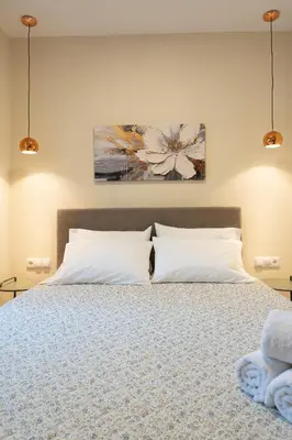 a bedroom with a bed with white pillows at Eviona Althea in Rhodes Town