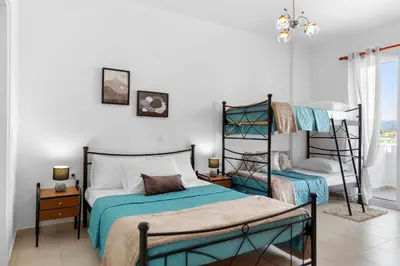 a bedroom with two bunk beds and a window at Aegean Breeze in Haraki
