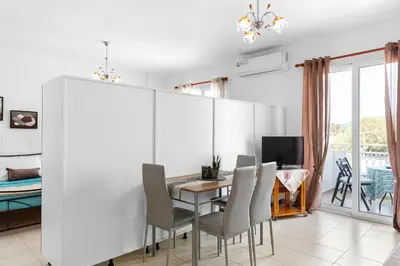 a dining room with a table and chairs at Aegean Breeze in Haraki
