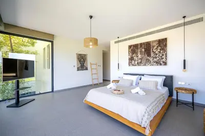 a bedroom with a bed and a flat screen tv at Filerimos Panorama Villa in Pastida