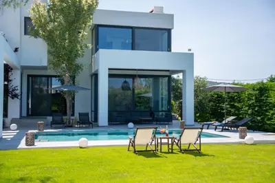 a villa with a swimming pool and lawn at Filerimos Panorama Villa in Pastida