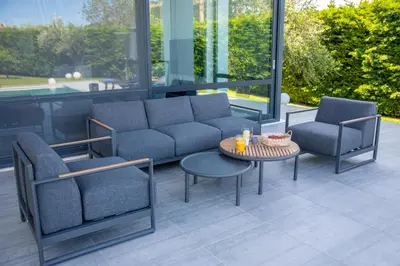 a patio with a couch and two chairs and a table at Filerimos Panorama Villa in Pastida