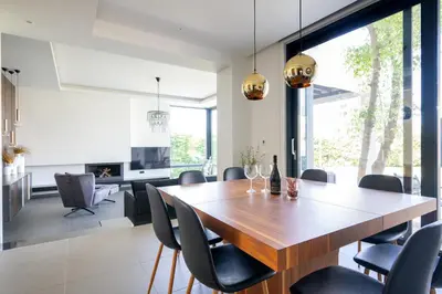 a dining room with a wooden table and chairs at Filerimos Panorama Villa in Pastida