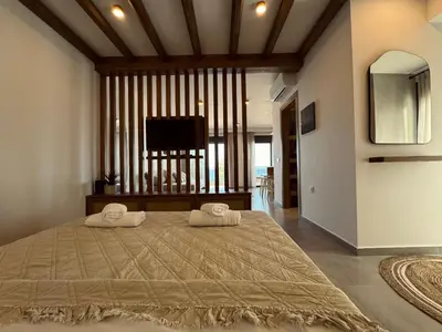a bedroom with a large bed with two towels on it at Aurora Seaside Luxury Suite in Vrachonisída touArchangélou