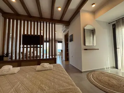 a bedroom with a bed with two towels on it at Aurora Seaside Luxury Suite in Vrachonisída touArchangélou
