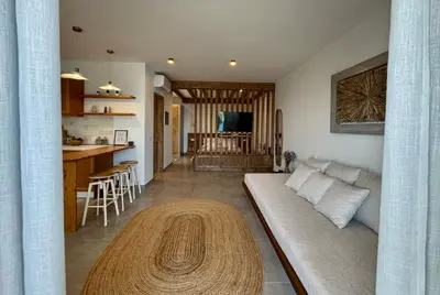 a living room with a couch and a table at Aurora Seaside Luxury Suite in Vrachonisída touArchangélou