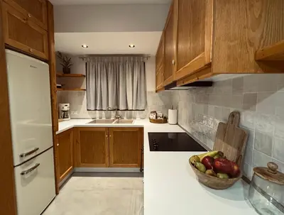 a kitchen with a bowl of fruit on the counter at Aurora Seaside Luxury Suite in Vrachonisída touArchangélou