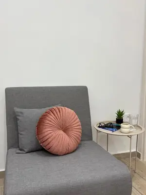 a pillow on a couch with a table at MariAnthi Apartment in Kremasti