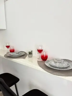 a table with two plates and glasses of wine at MariAnthi Apartment in Kremasti