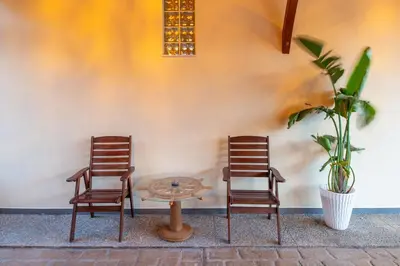 two chairs and a table next to a wall at Villa Arianna in Kalathos
