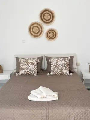 a bedroom with a bed with towels on it at Andri's Garden House in Psinthos