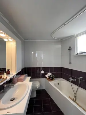 a bathroom with a tub and a toilet and a sink at Andri's Garden House in Psinthos