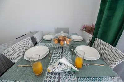 a table with plates and glasses of orange juice at Pelagos in Vrachonisída touArchangélou