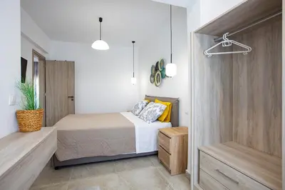 a bedroom with a bed and a closet at RENI APARTMENT Faliraki in Faliraki