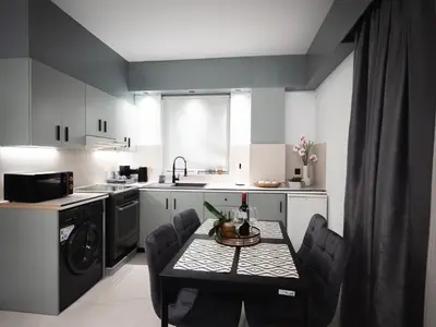 a small kitchen with a table and chairs in it at Sea Side Apartment Rhodes City Center in Rhodes Town